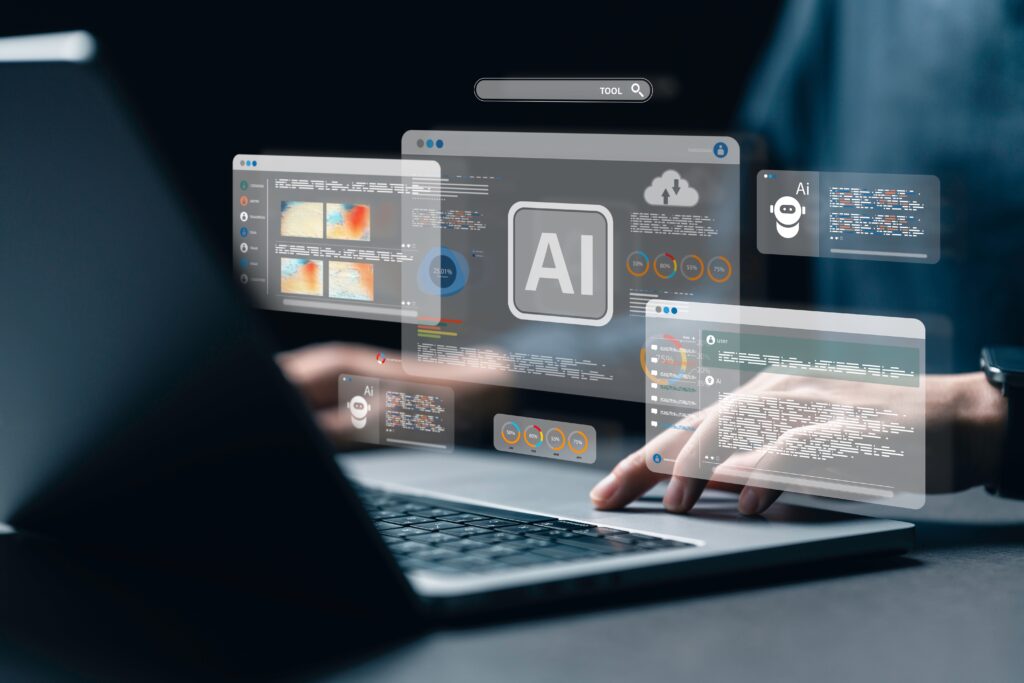 Person using AI development tools on a laptop with digital interface screens displaying machine learning models, data analytics, and code overlays for artificial intelligence applications.