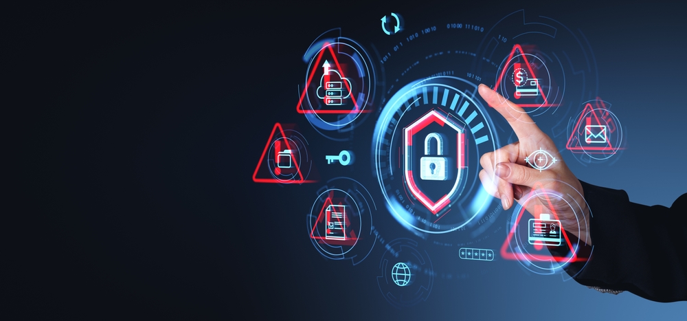 A hand interacting with a futuristic cybersecurity interface, featuring warning icons and a central shield lock symbol, representing data protection, threat detection, and cloud security management.